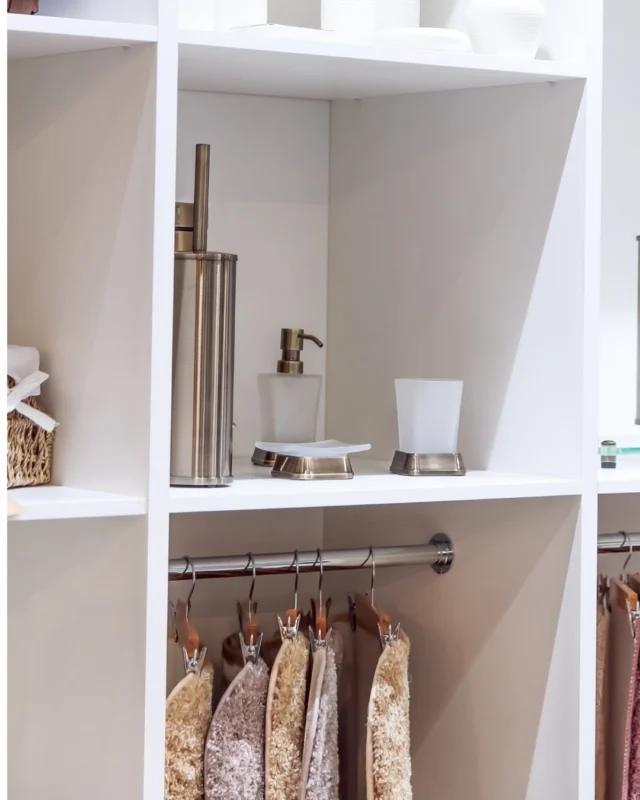 White open shelving with a hanging rail and bathroom accessories