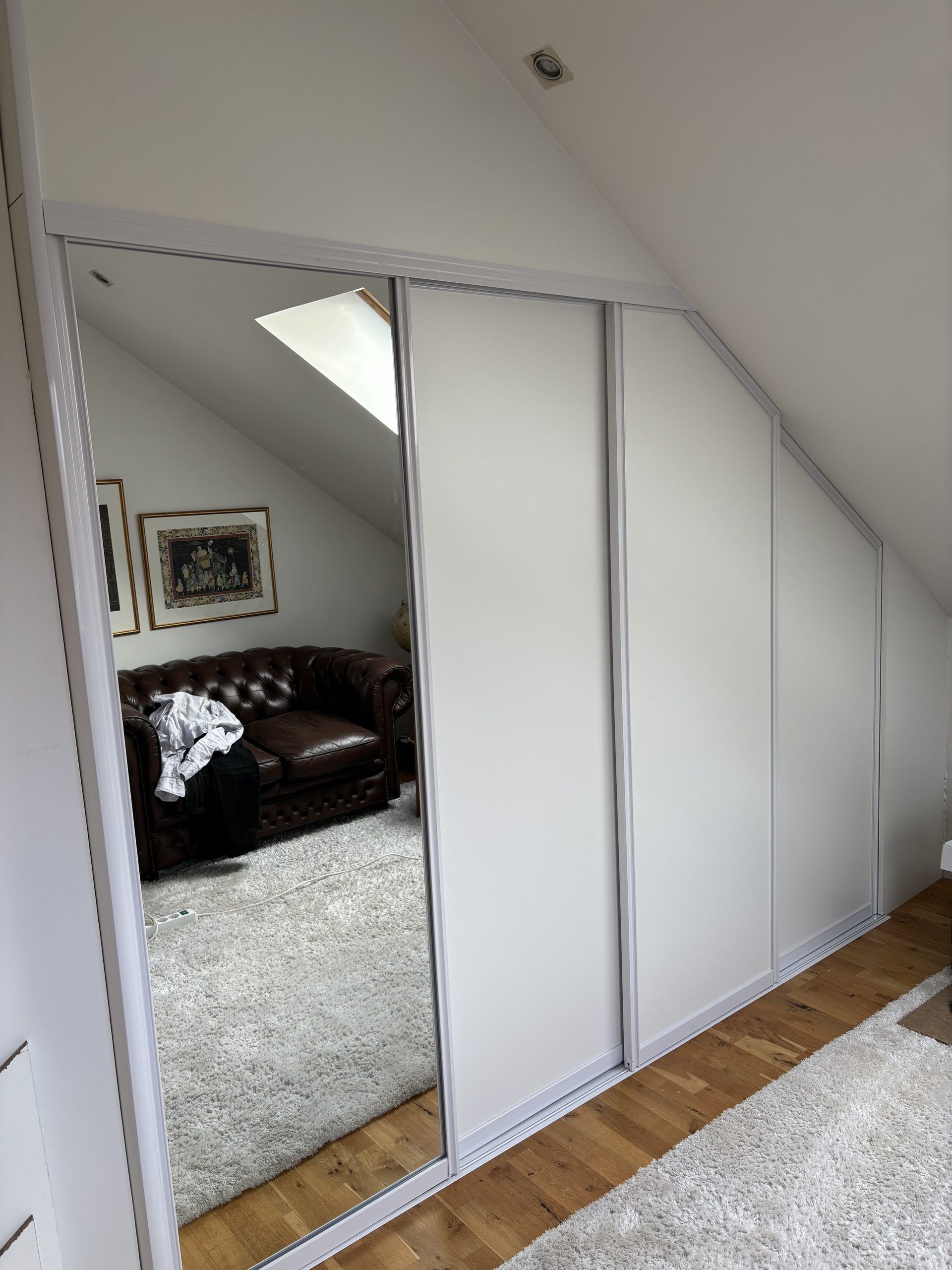 White sliding door under a slope, shown open