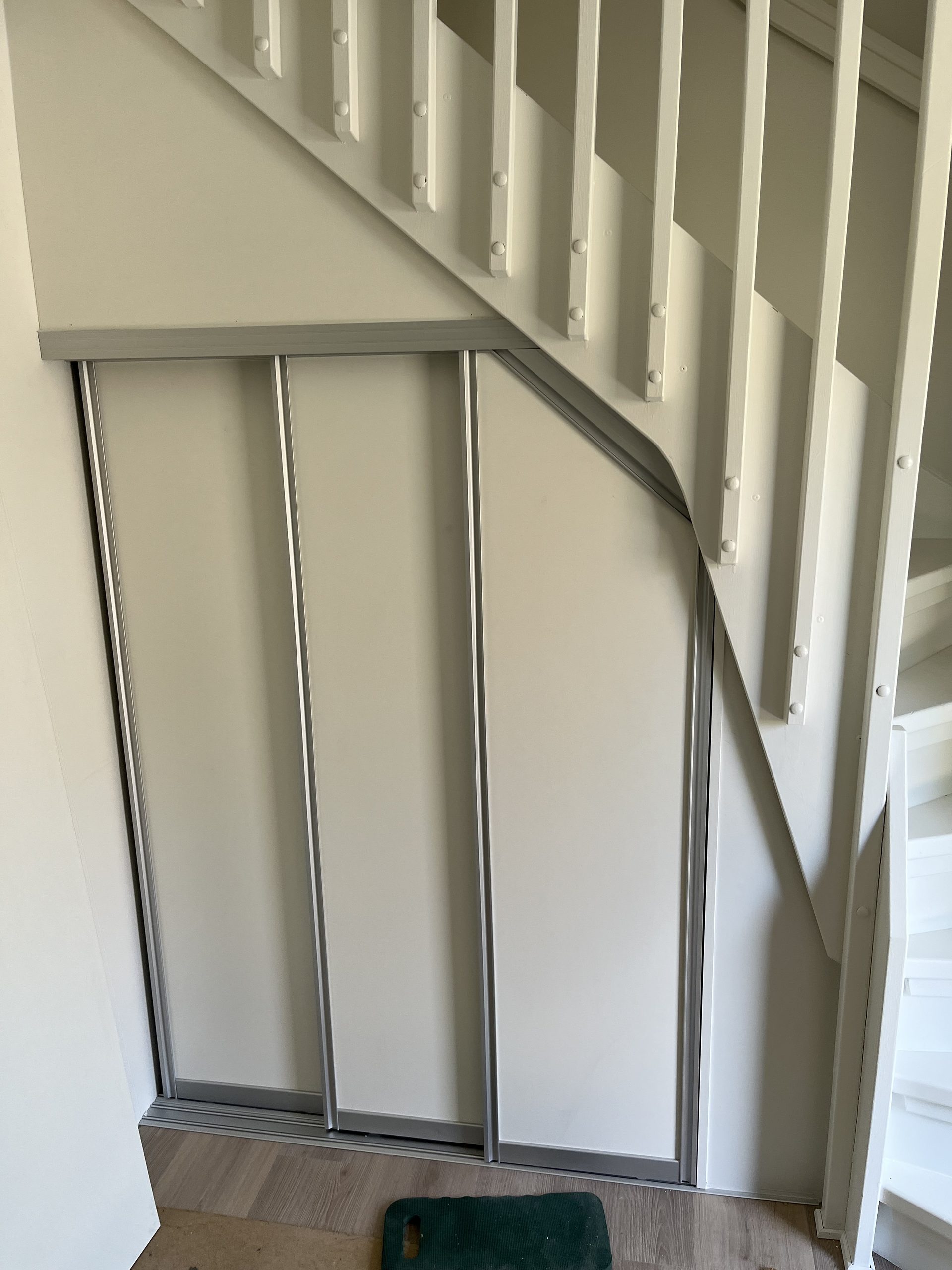 Beige doors angled to follow the stairs above