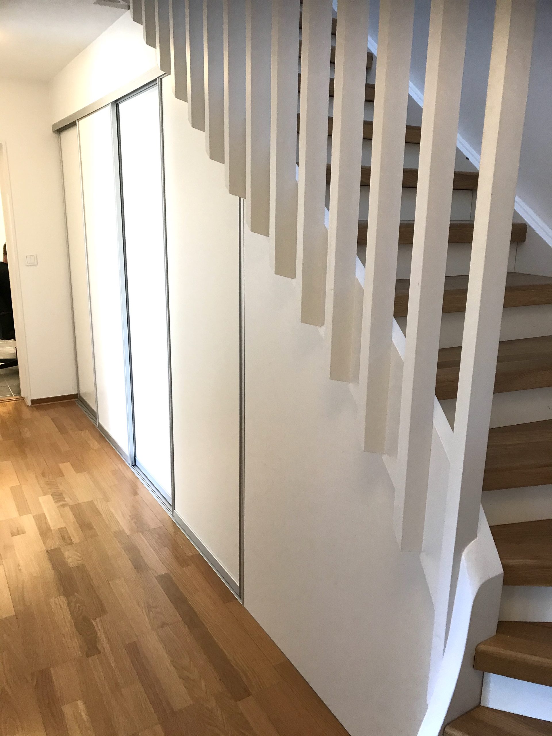 Beige doors along a hallway, wood floor