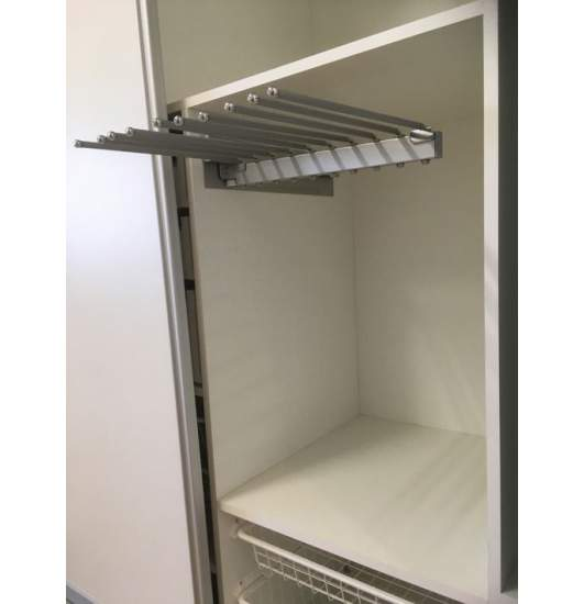 Pull-out trouser rack with metal rails extended from a wardrobe section.